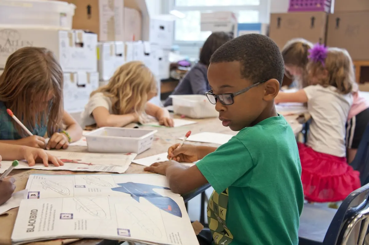 Child and adult working together at a learning table